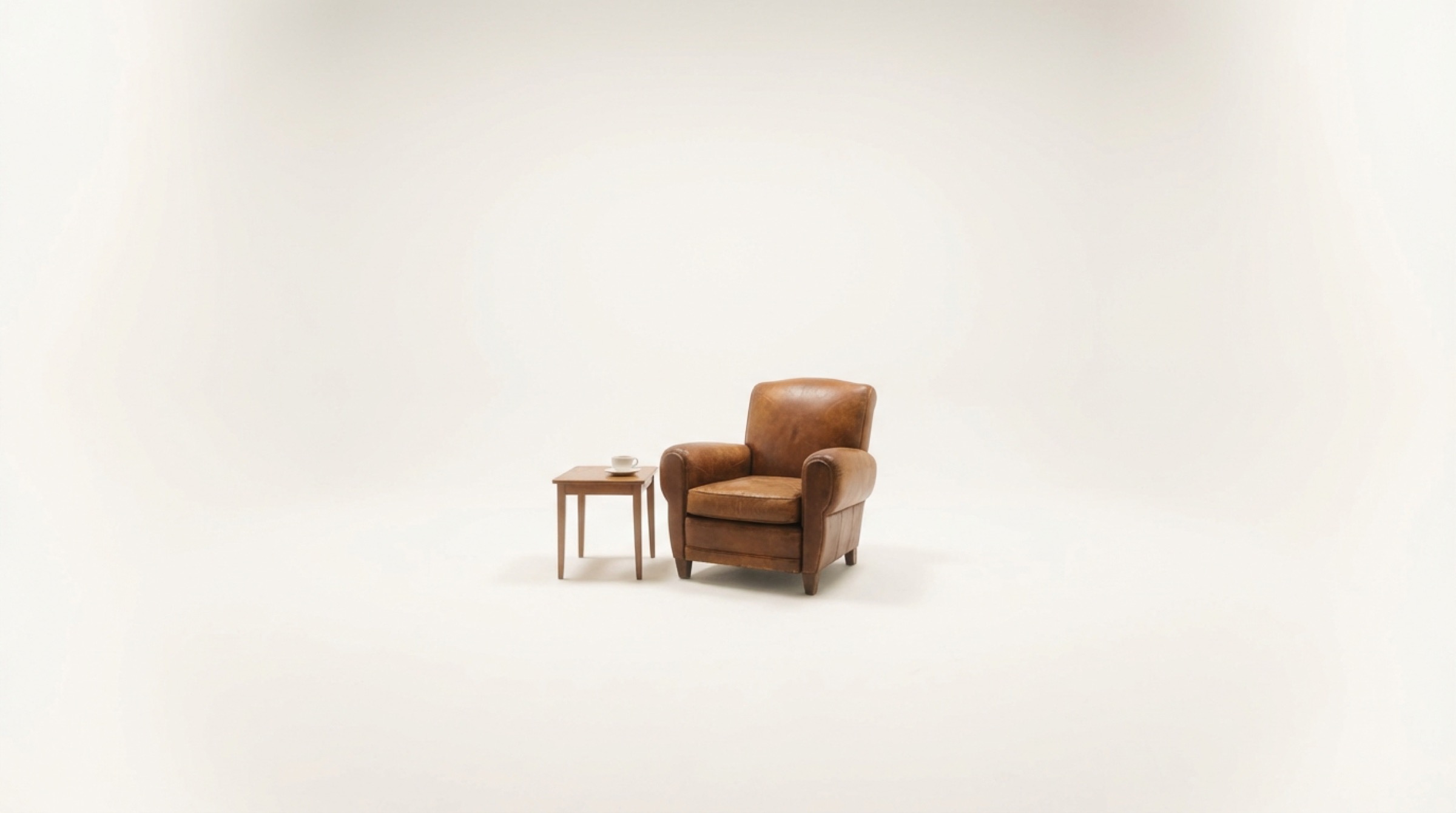 Leather armchair in a minimal white studio